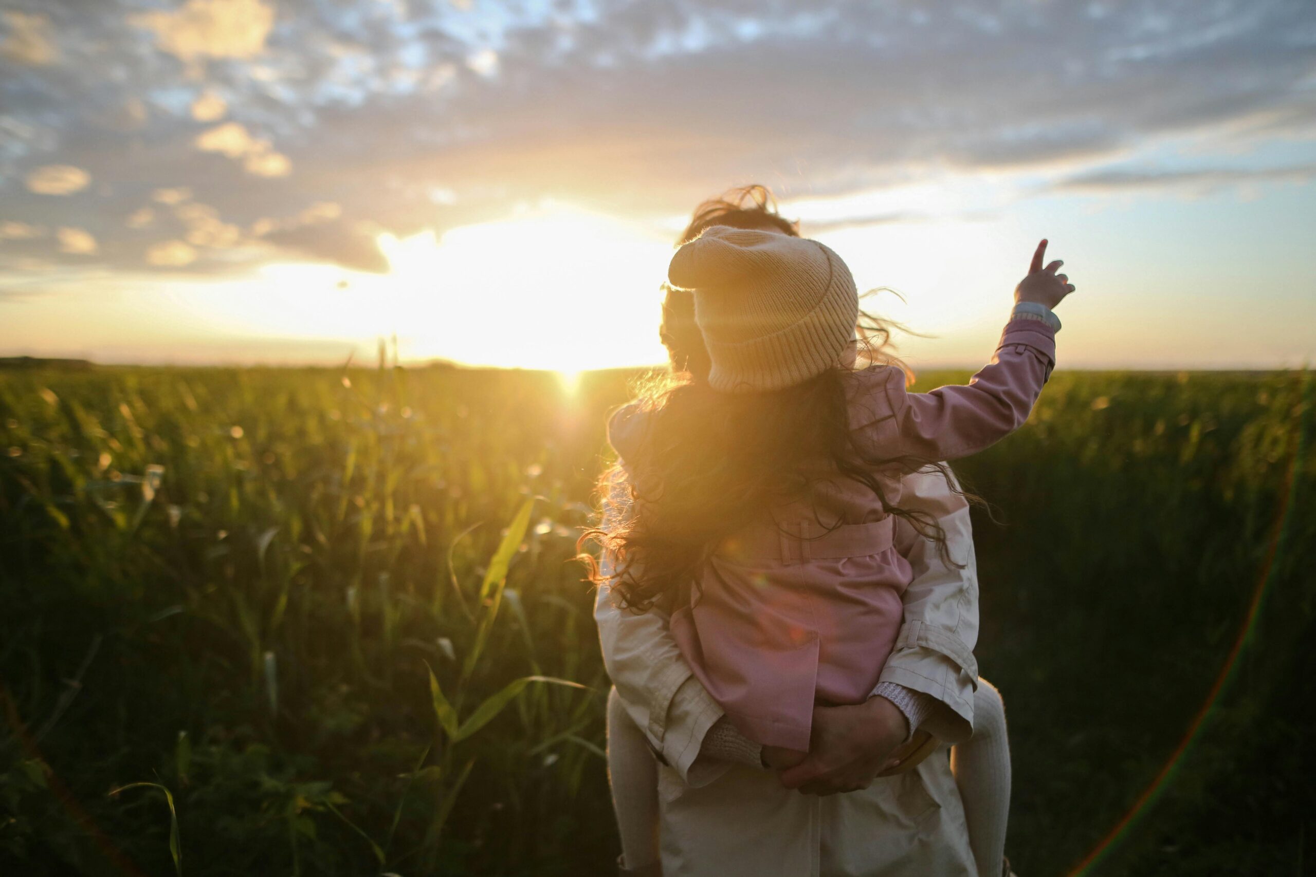 o mne, poslani1 o mne, poslani1. a woman carrying a child in a field.
